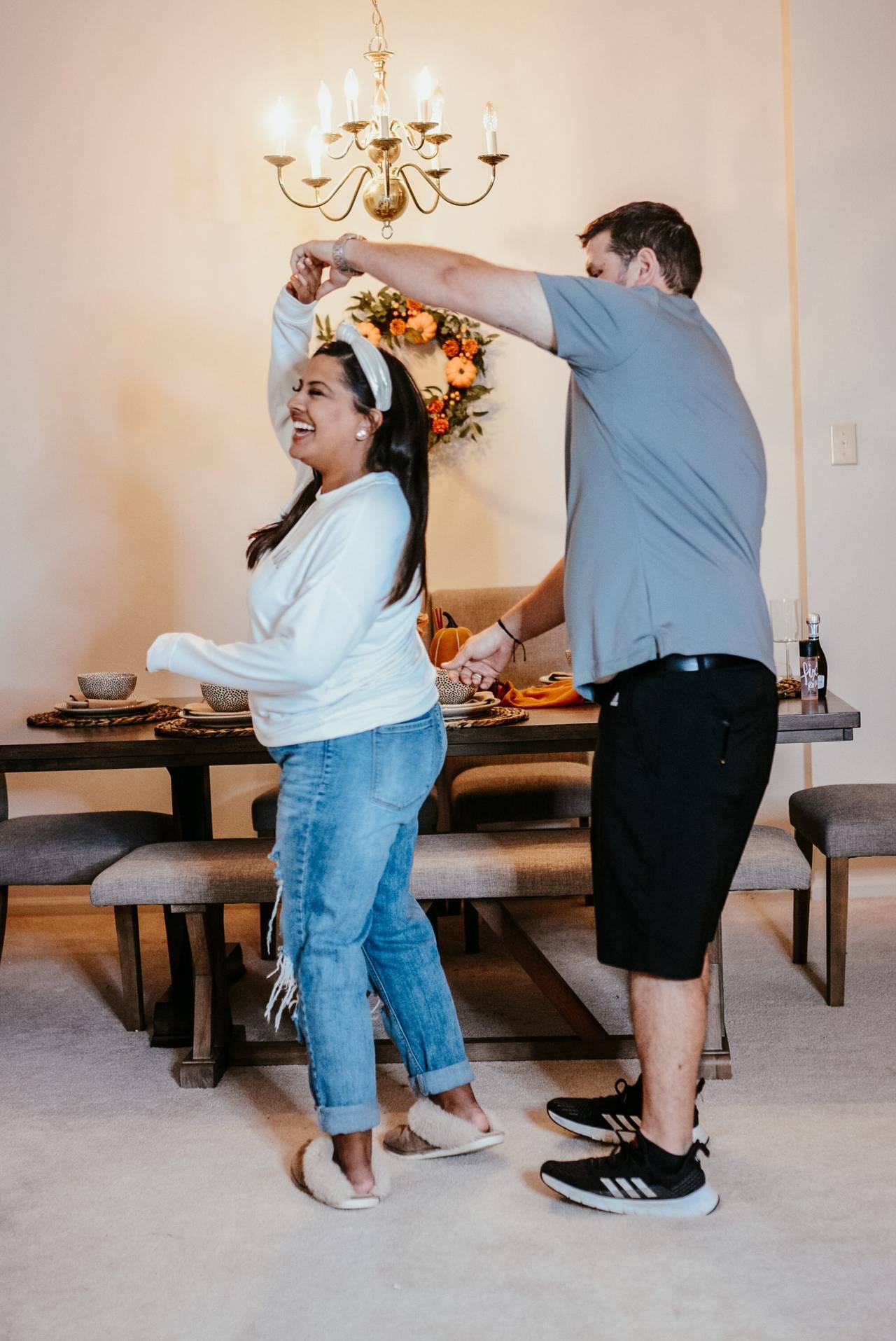 A couple dancing together in their dining room